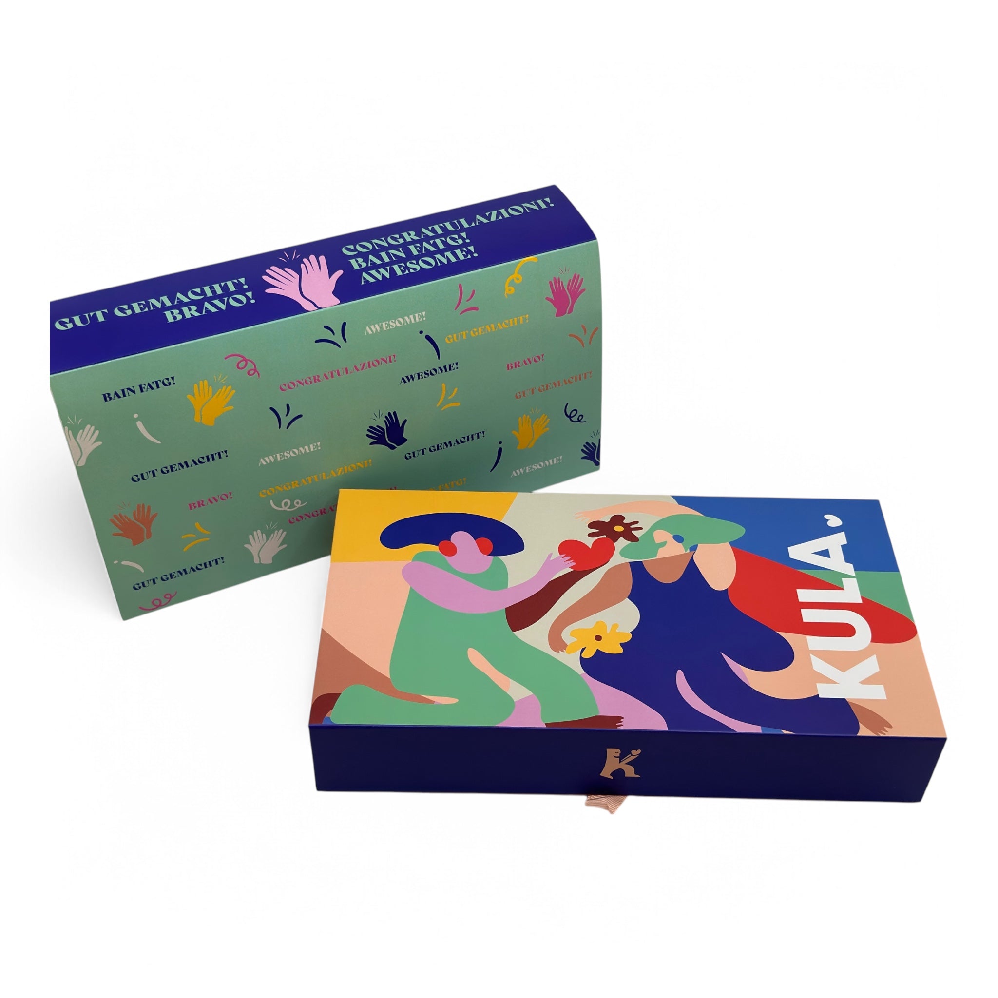 KULA gift box with a vibrant 'Well Done' sleeve in multiple languages, including 'Gut Gemacht!' and 'Awesome!' Paired with the colourful KULA signature box, filled with delicious homemade brownies