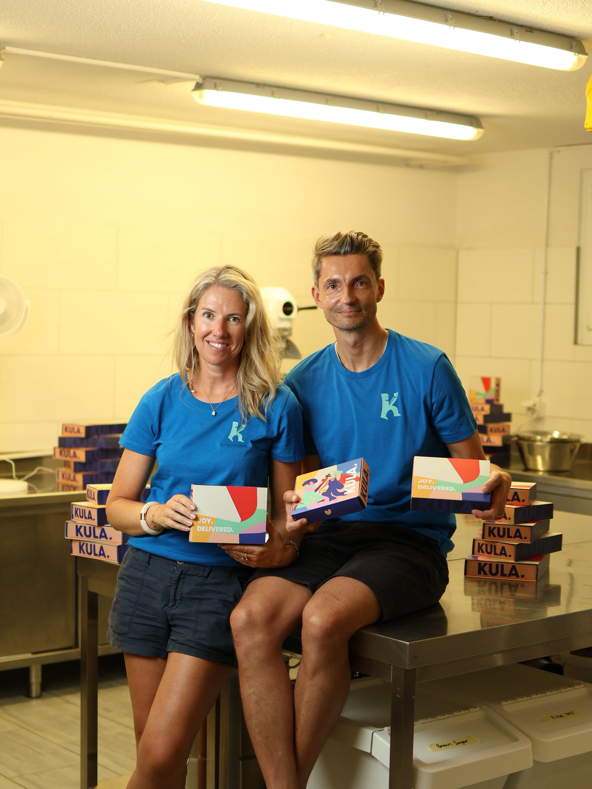 KULA Founders, Thomas and Marianne in the KULA kitchen holding KULA boxes