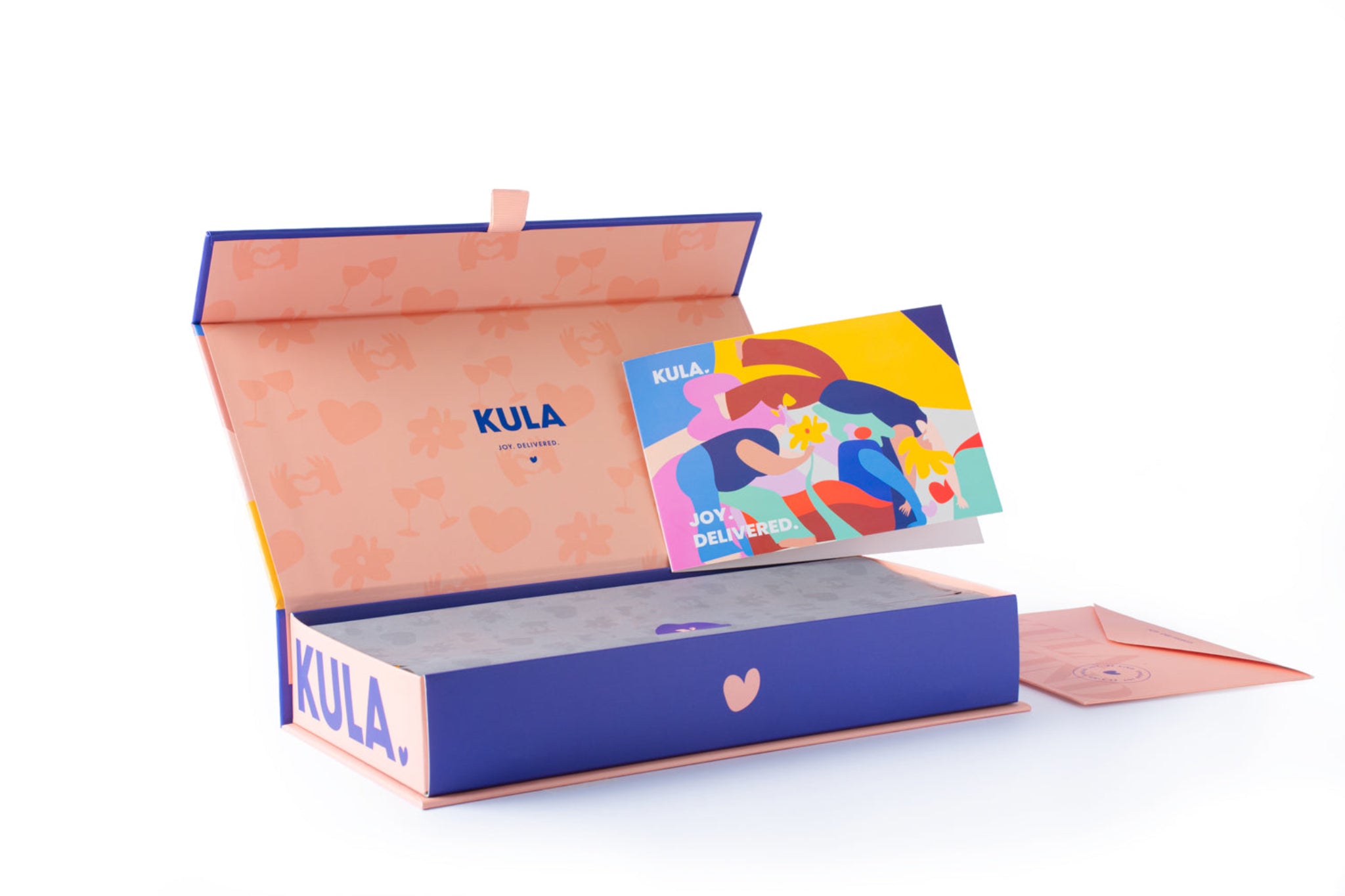 An open KULA gift box featuring a beautifully designed 'Joy Delivered' card with vibrant, colourful artwork. The box showcases its premium packaging with a soft pink interior, KULA branding, and space for a handwritten note or video QR code, perfect for personalised gifting.