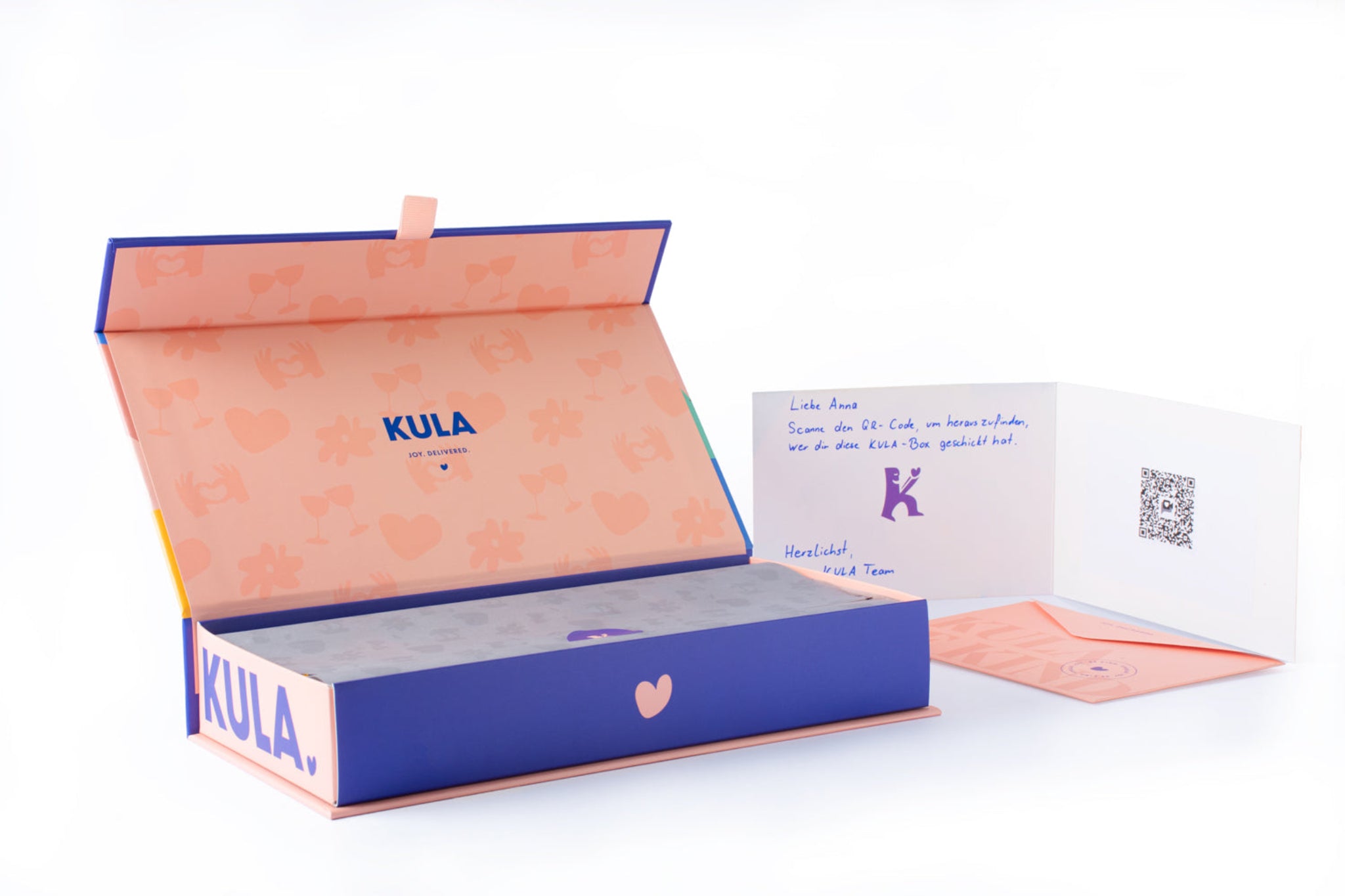 An open KULA gift box showcasing its elegant interior design, accompanied by a handwritten card with a personalised message and a QR code for a special video message. A thoughtful and unique gifting experience.