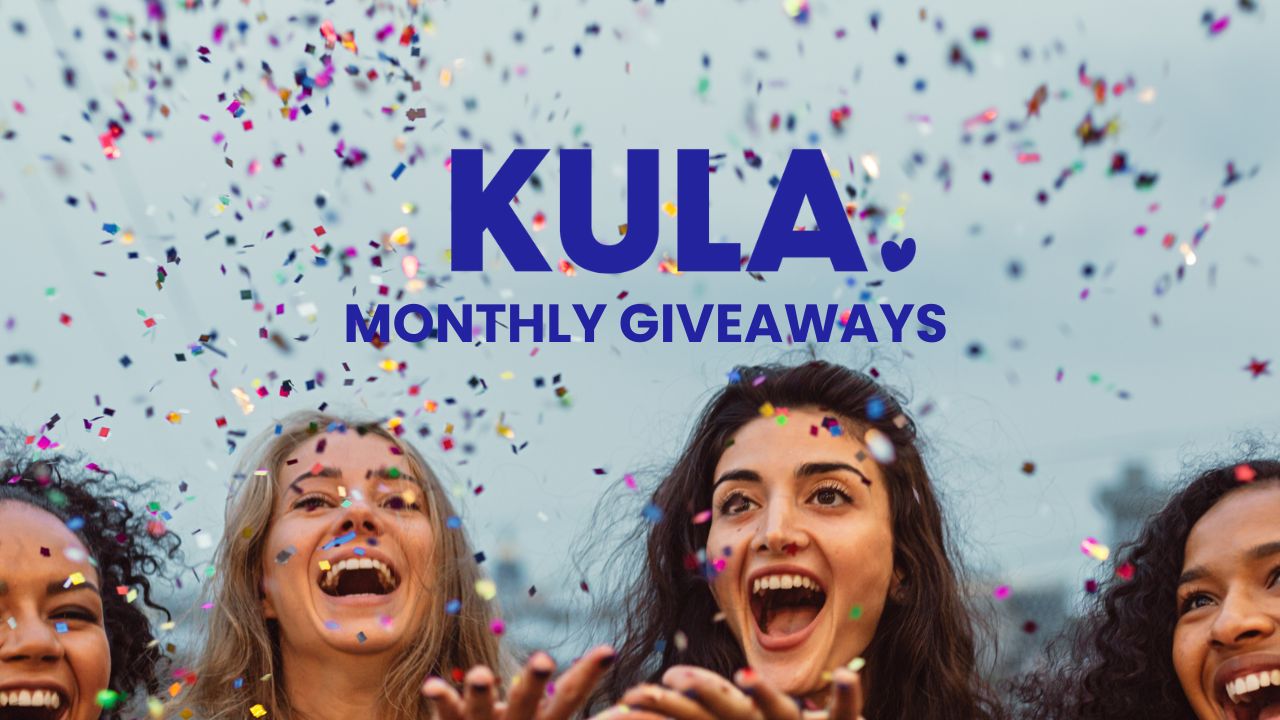 Group of women joyfully throwing confetti, celebrating KULA Monthly Giveaways and the spirit of spreading kindness.