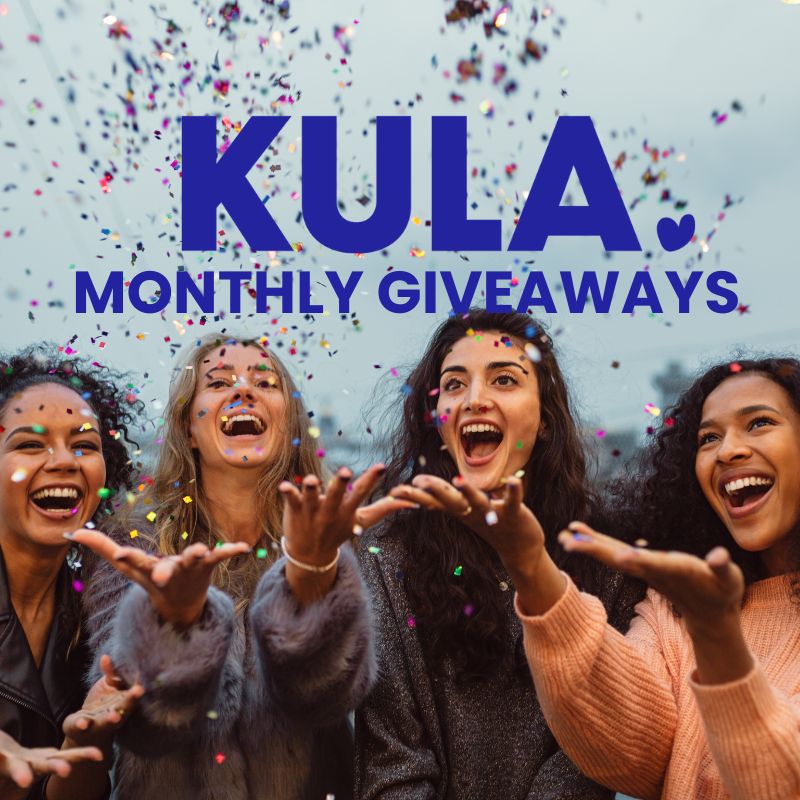 Group of women joyfully throwing confetti, celebrating KULA Monthly Giveaways and the spirit of spreading kindness
