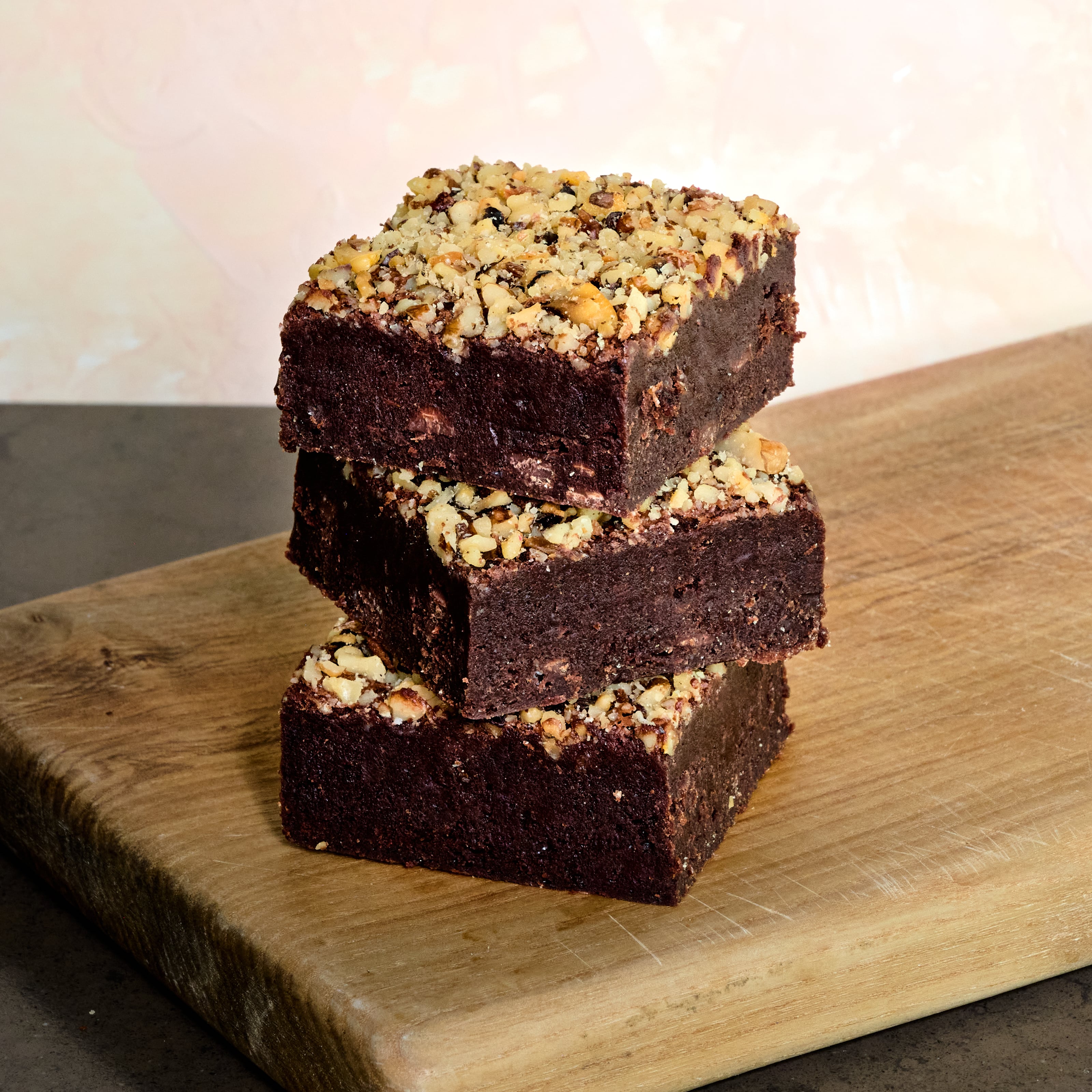 Stack of 3 KULA Nutty Brownies. Gooey brownies with chopped walnut topping. 