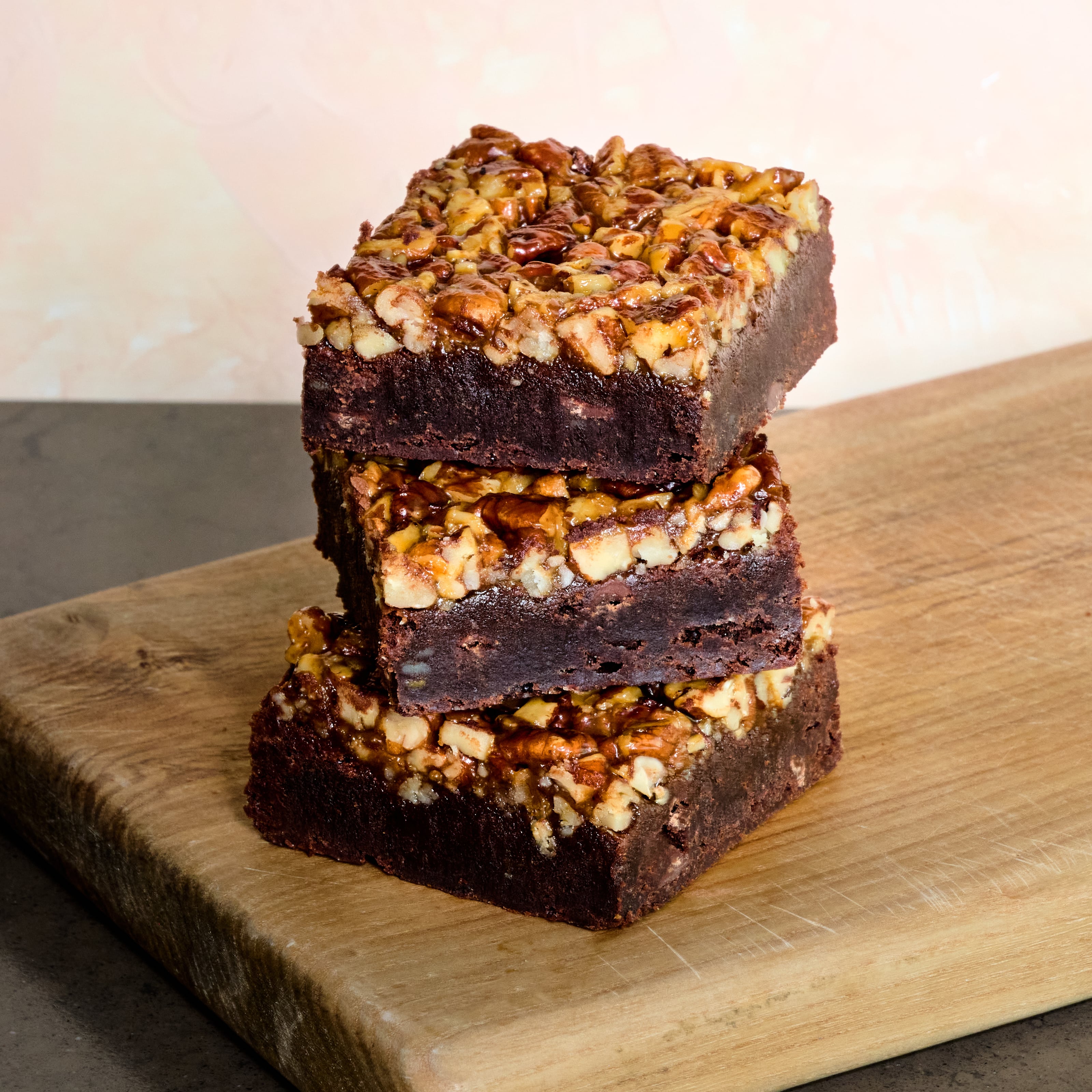 Stack of 3 KULA Salted Caramel Brownies. Gooey brownie with homemade salted caramel and pecan topping. 