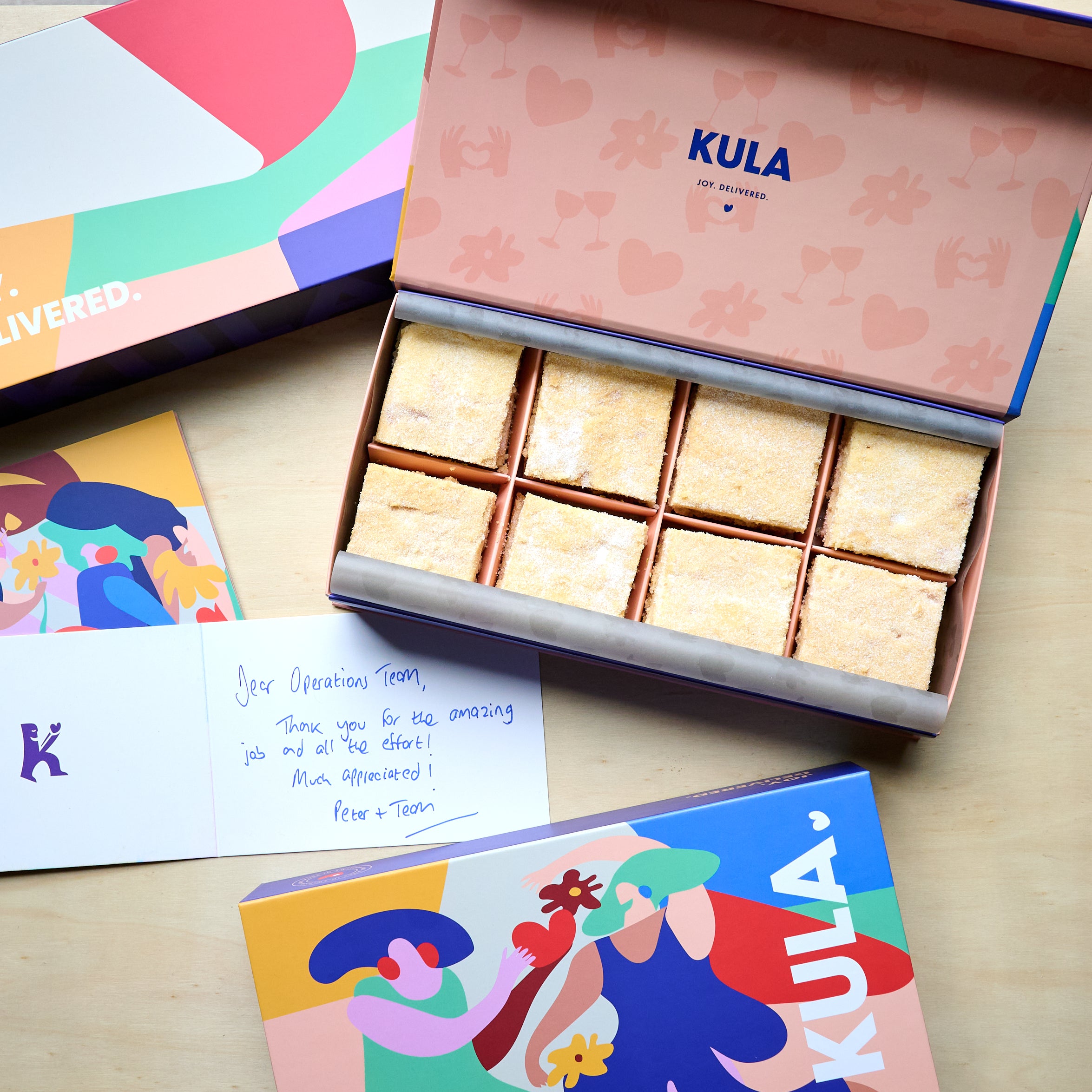 Beautiful open KULA gift box with 16 homemade Irish shortbread, a handwritten card and a picture of a vibrant closed KULA box