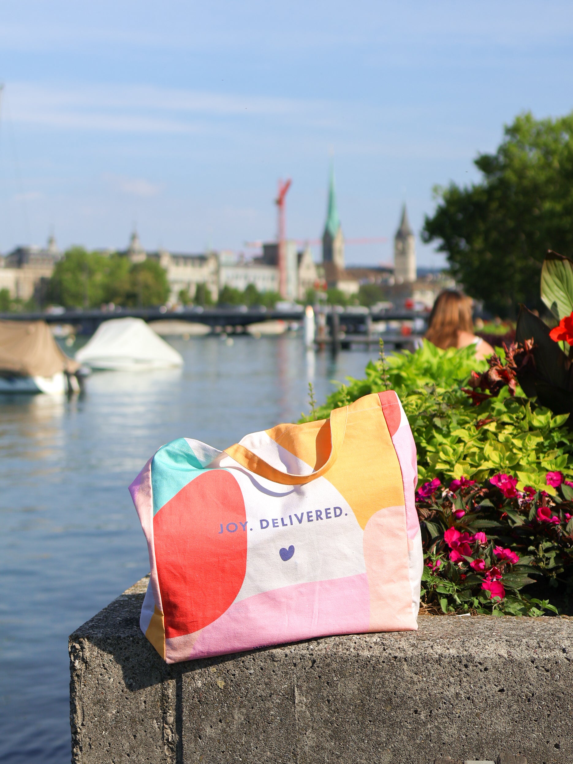 KULA tote bag sitting on stone by Limmat river in downtown Zürich